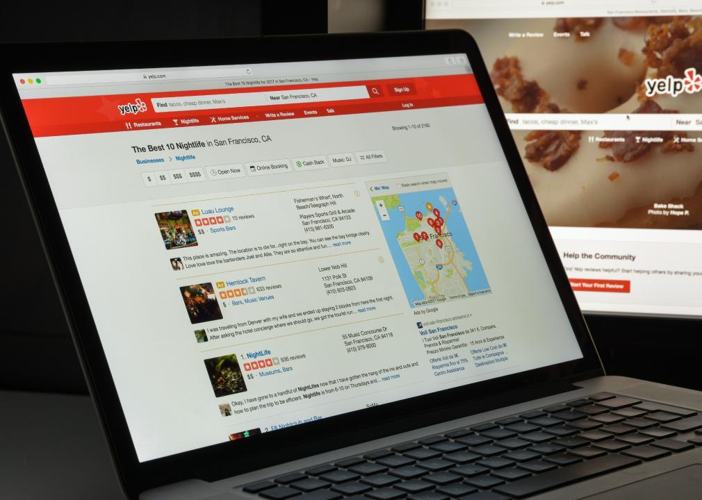 The Yelp website is displayed up on a laptop screen.